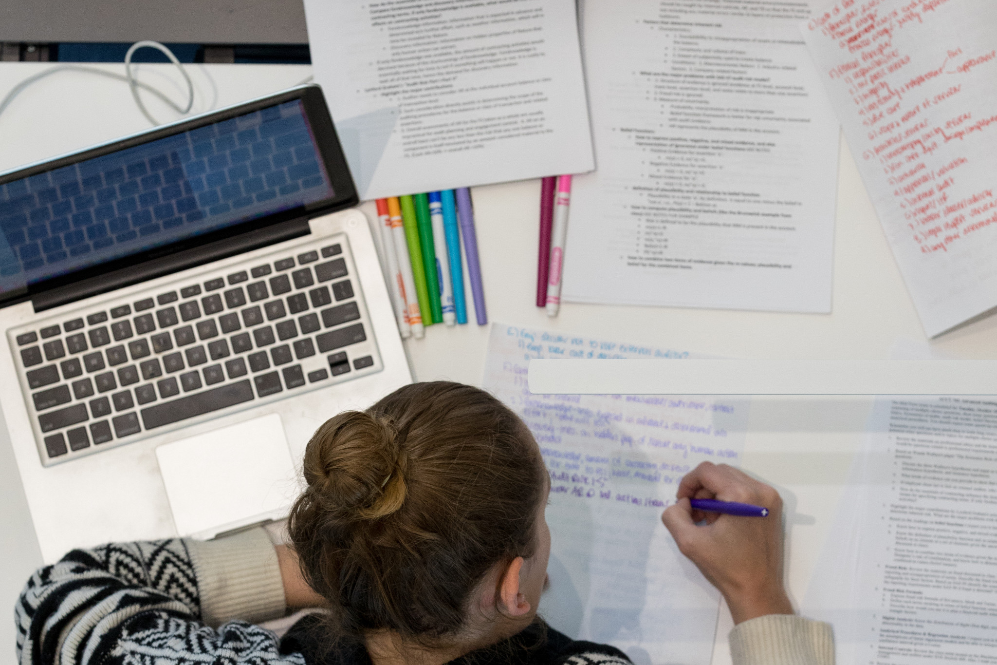 Student studying with computer and notes