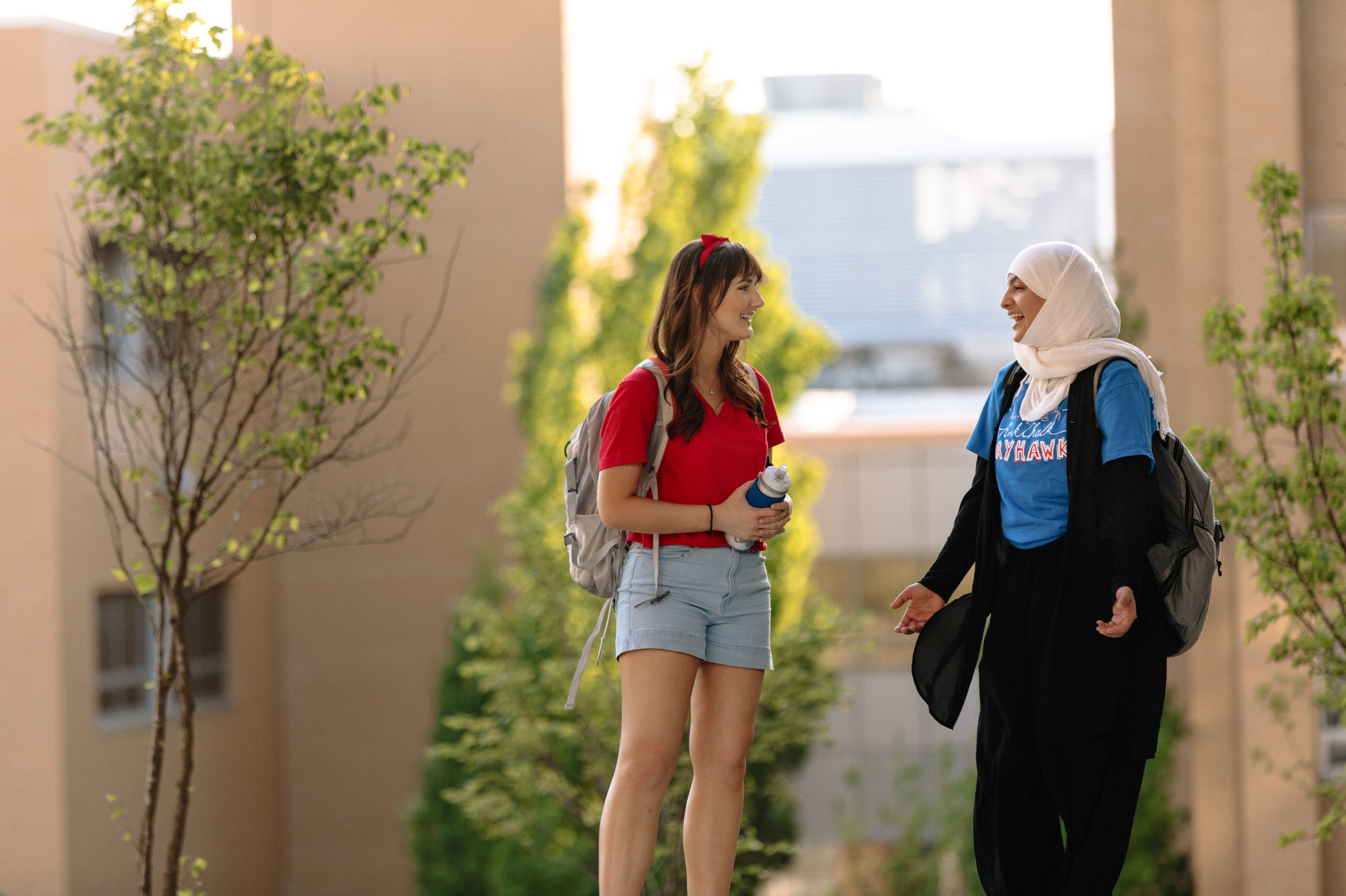 Students standing and talking and smiling