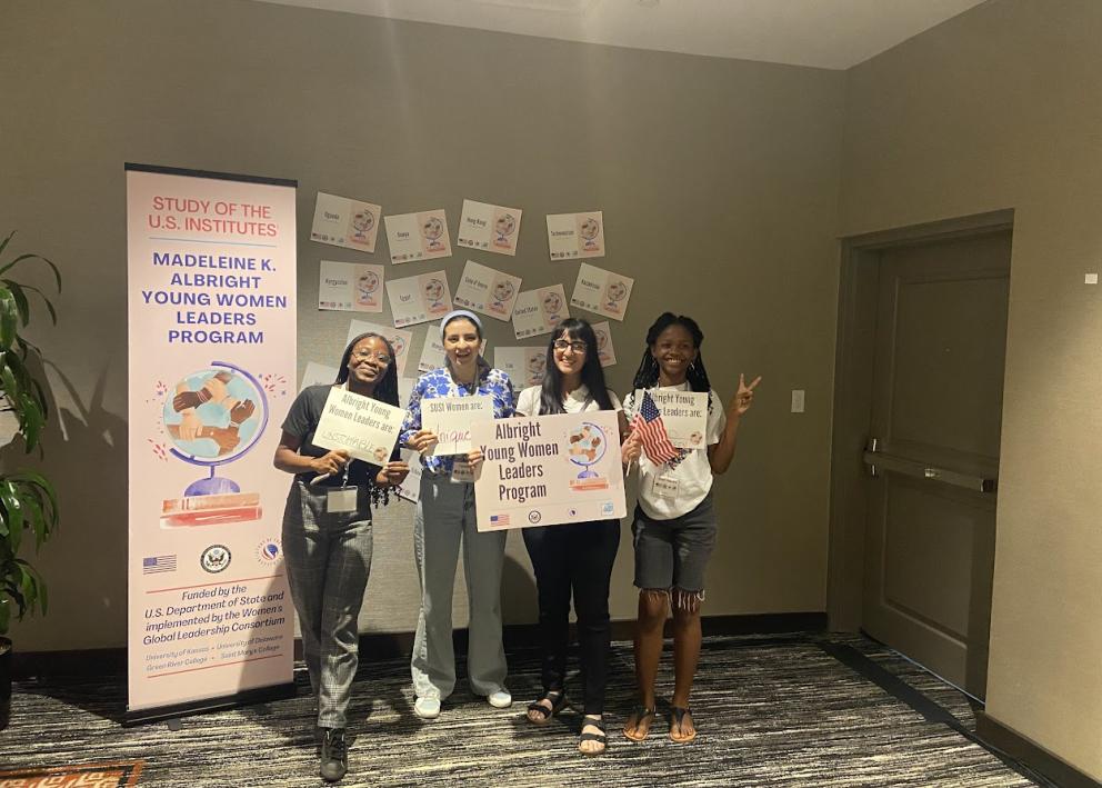 4 participants posing with Albright Young Women Leaders program signs
